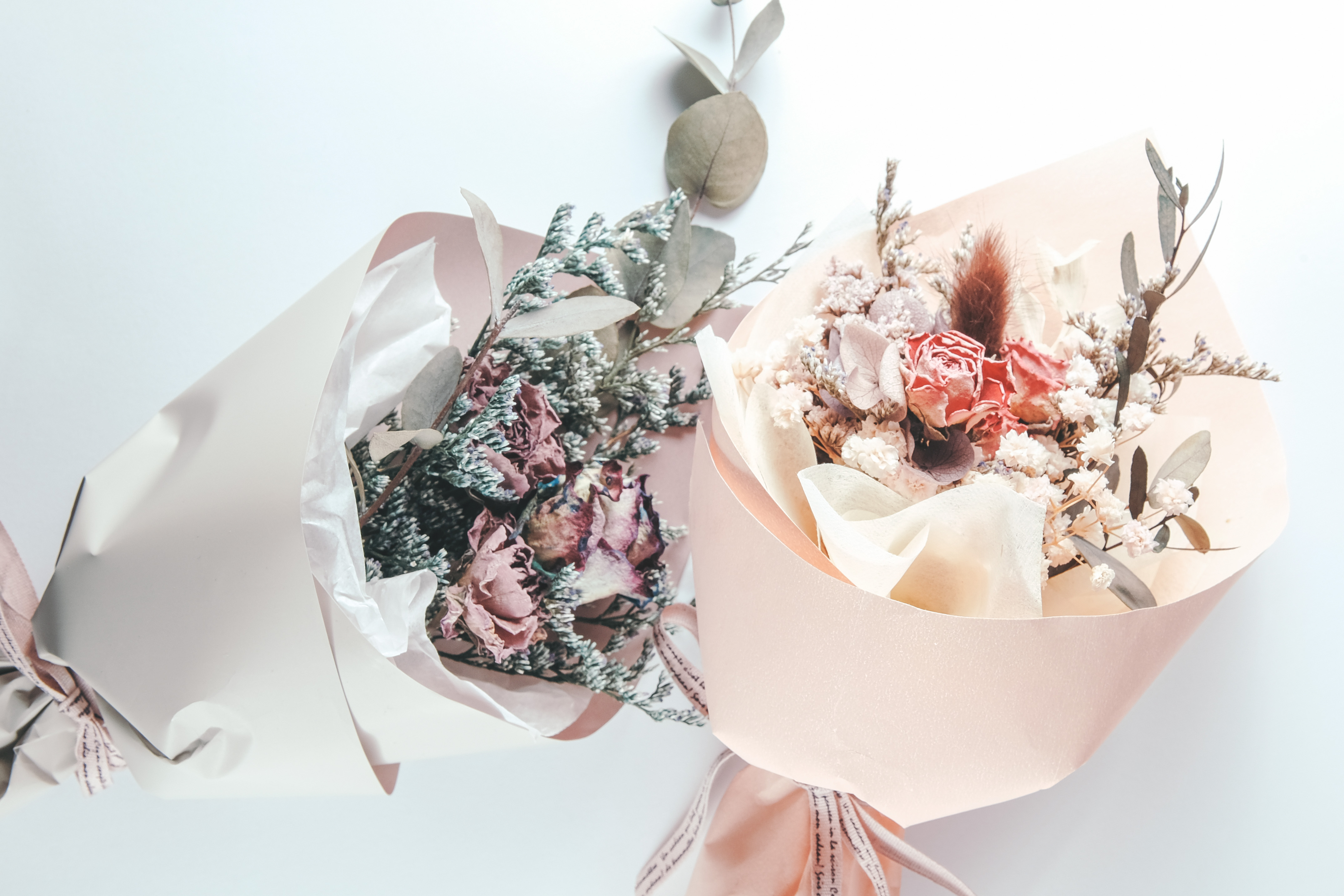 Two dried bouquets wrapped in paper.