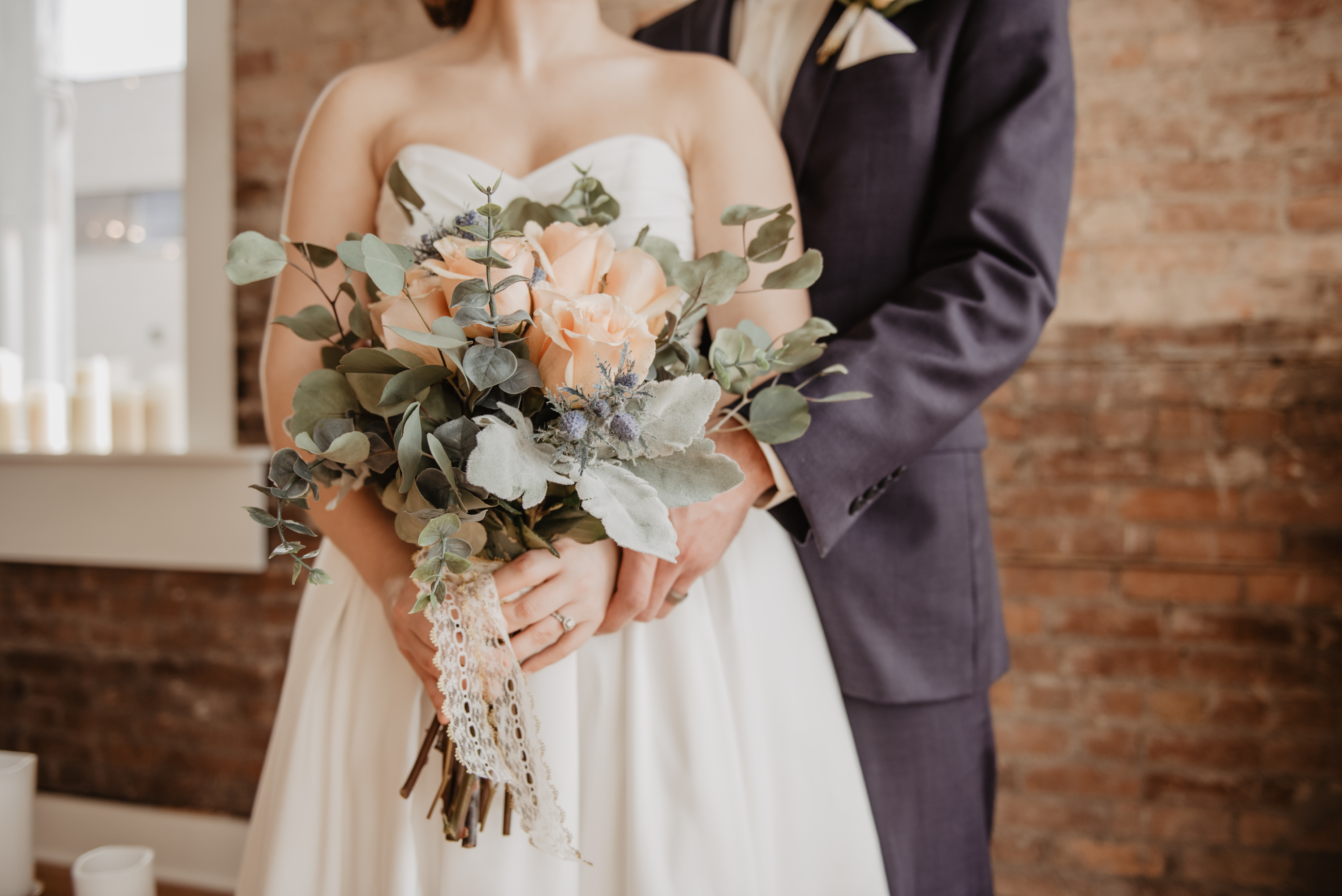 A couple holding a Wedding bouquet.